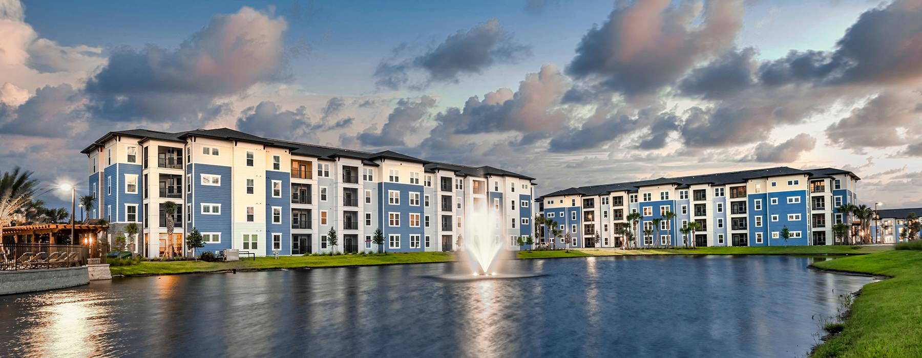 Pond View Over Building Exteriors with Sunset